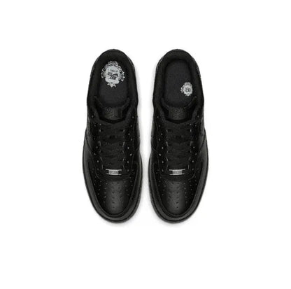 Black low-top sneaker pair, top view with laces, perforated toe and lace eyelets