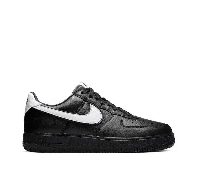 Black low-top sneaker with white Nike swoosh and black lace-up upper
