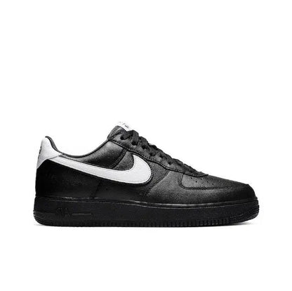 Black low-top sneaker with white Nike swoosh and black lace-up upper