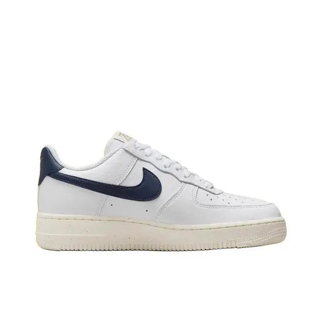 Nike Air Force 1 low-top sneaker side view in white leather with navy swoosh