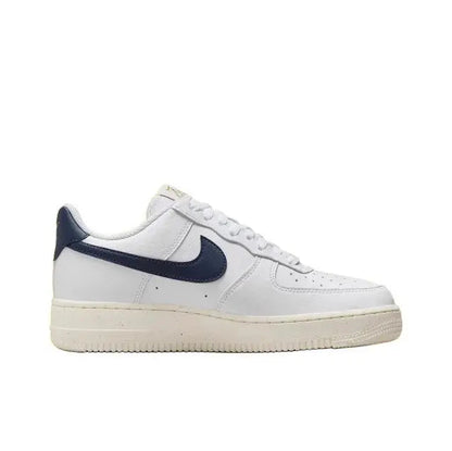 Nike Air Force 1 low-top sneaker side view in white leather with navy swoosh