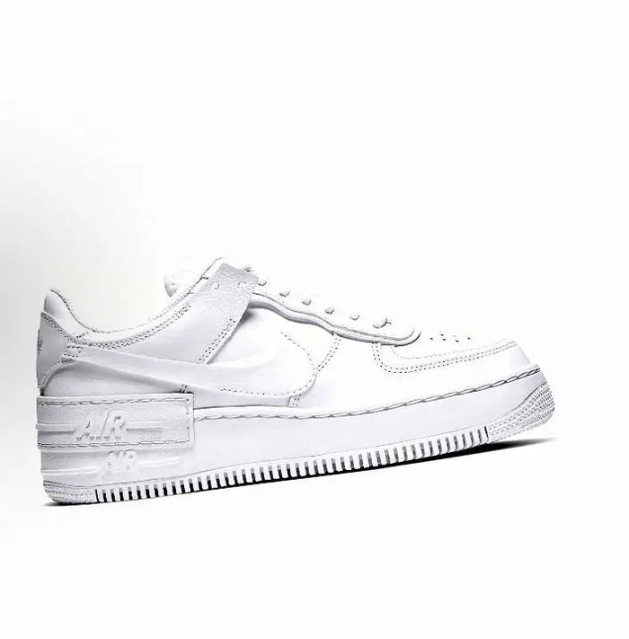 White low-top leather sneaker side view with Nike Swoosh, lace-up, stitched midsole