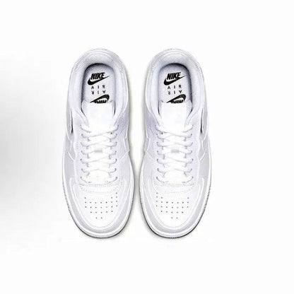 Pair of white low-top sneakers with lace-up eyelets and Nike Air tongue label