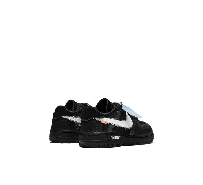 Black low-top Nike Air Force 1 sneakers, rear view with orange lace tag