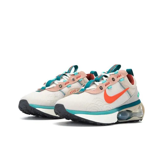 Pair of light sneakers with orange swoosh, teal laces, and Air Max sole