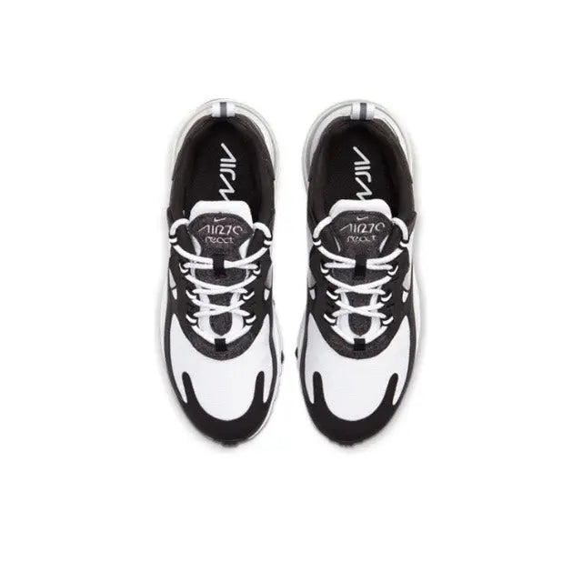 Low-top sneakers top view in white with black accents and lace-up