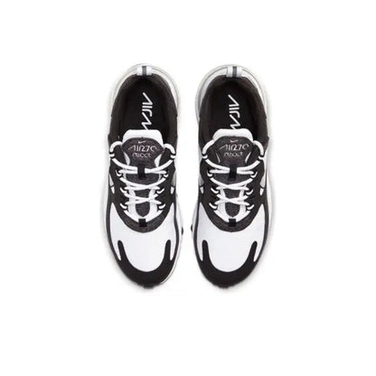Low-top sneakers top view in white with black accents and lace-up