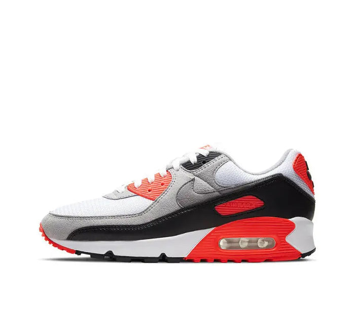 Air Max 90 running sneakers in white, gray, black, and red with orange lace tips