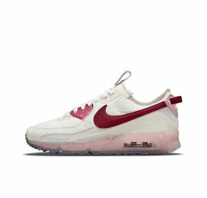 White Nike Air Max 90 low-top sneakers with burgundy swoosh and pink-tinted sole