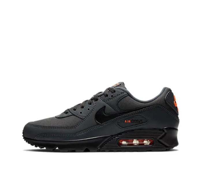 Nike Air Max 90 sneakers in dark charcoal black with orange accents and Air heel window