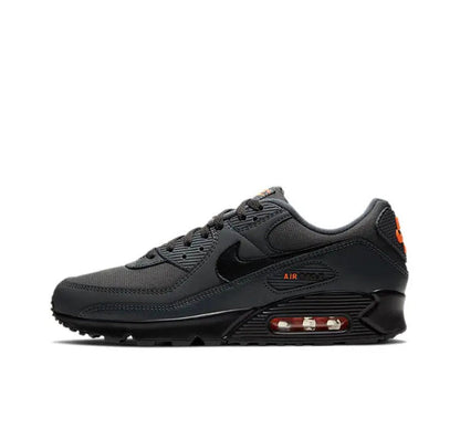 Nike Air Max 90 sneakers in dark charcoal black with orange accents and Air heel window