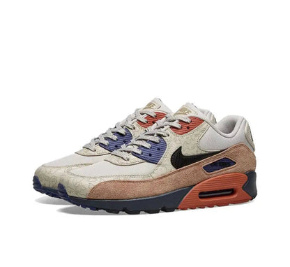 Nike Air Max 90 sneakers, cream laces, navy panel, brown toe, orange heel air unit