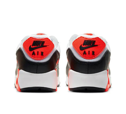 Air Max 90 sneakers with white heel caps, black collar, and red “AIR” tags