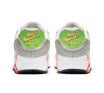 Air Max 90 sneakers, white heel with neon green Nike AIR badge, navy sole edge