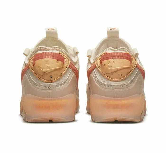 Air Max 90 sneaker pair, light tan uppers with orange heel trim and clear air unit