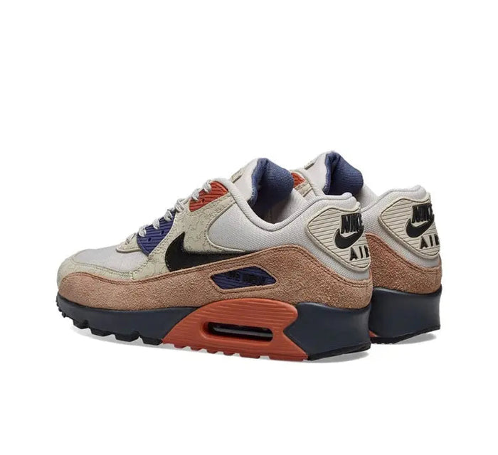 Nike Air Max 90 sneakers with cream mesh, navy heel, brown midsole, orange air window