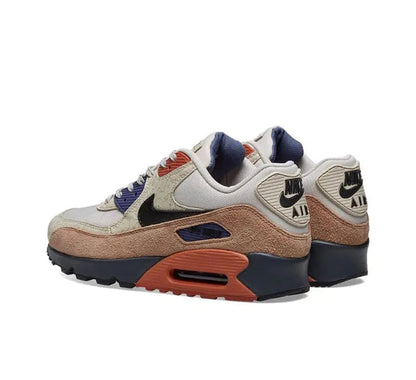 Nike Air Max 90 sneakers with cream mesh, navy heel, brown midsole, orange air window