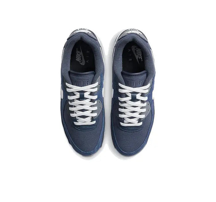 Low-top sneakers with dark blue uppers, white laces, and white midsoles