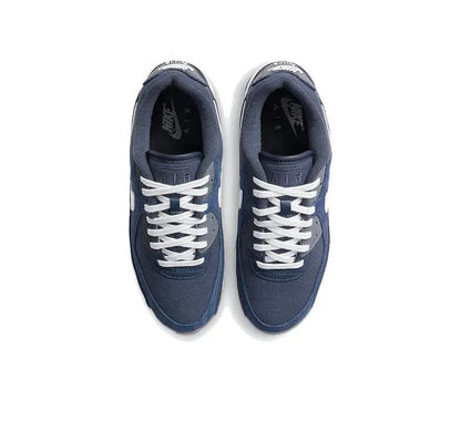 Low-top sneakers with dark blue uppers, white laces, and white midsoles