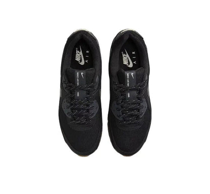 Nike Air Max 90 sneakers showing black uppers and lace eyelets