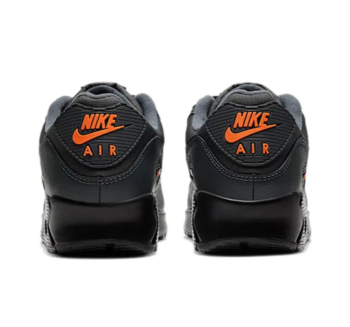 Nike Air Max 90 sneakers with heel branding, dark charcoal black and orange Nike Air logo