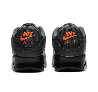 Nike Air Max 90 sneakers with heel branding, dark charcoal black and orange Nike Air logo
