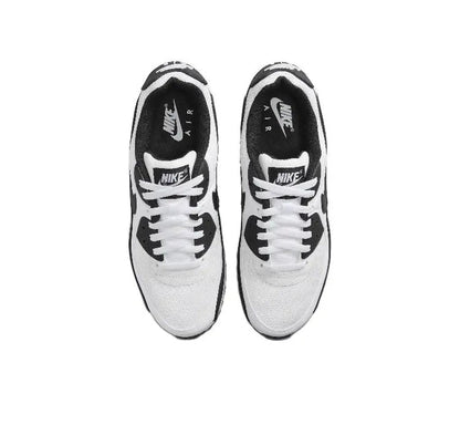 Air Max 90 sneaker top view, white laces with black Nike and Air heel tags