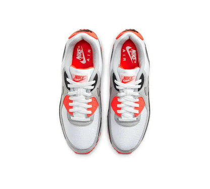 Air Max 90 shoes with white uppers, red lace stays, and “AIR” branding at tongue