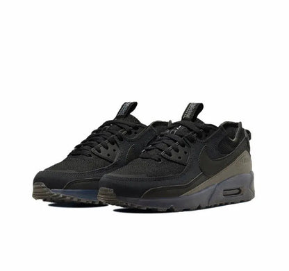 Nike Air Max 90 sneakers in black with olive-gray accents and blue Air unit