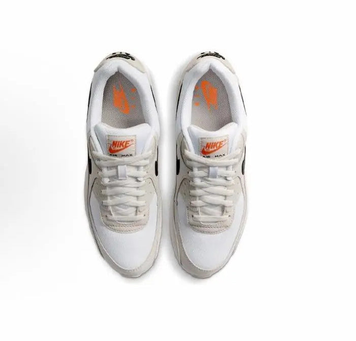 Nike Air Max 90 sneakers, white lace-up uppers with gray lining and orange NIKE logo
