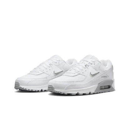 Nike Air Max 90 sneaker in white/grey, angled front view with swoosh