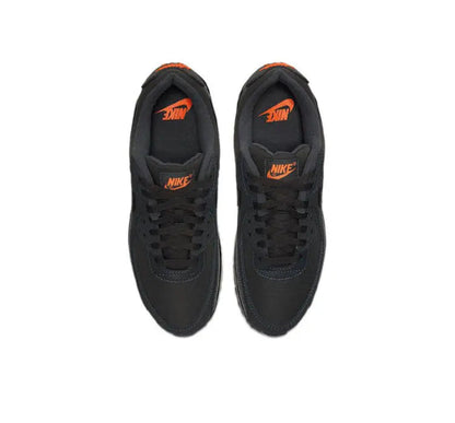 Nike Air Max 90 sneakers top view, dark charcoal black uppers with orange accents