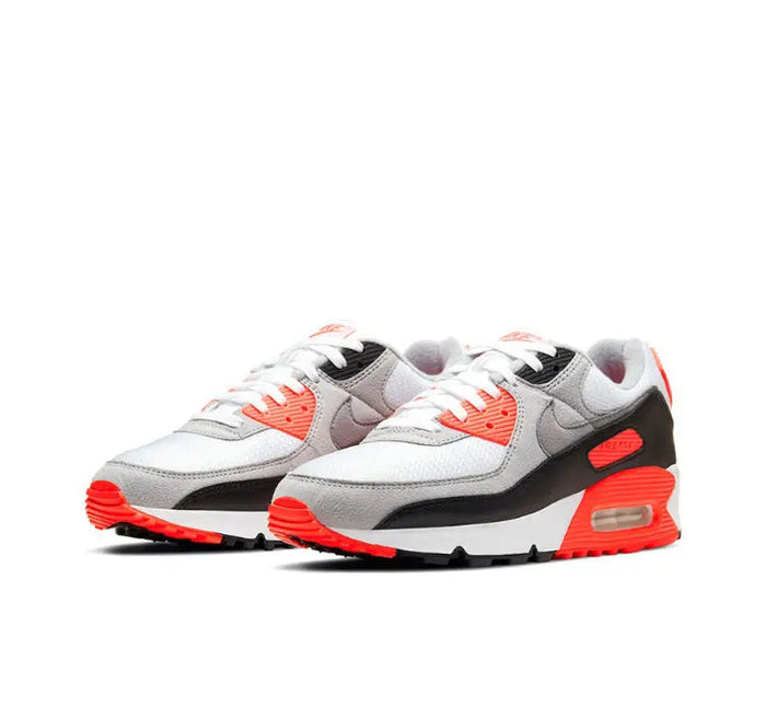 Air Max 90 sneakers with white and gray panels, black stripe, and red air unit