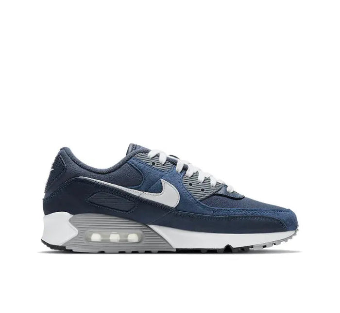 Low-top sneakers in dark blue with white swoosh and visible Air Max heel window