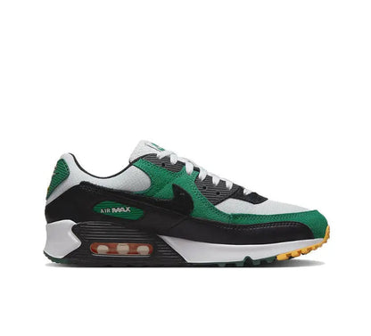 Nike Air Max 90 sneaker side view, green overlays and white panels with black midsole