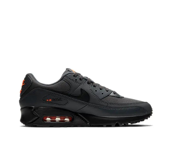 Nike Air Max 90 sneakers side view, dark charcoal black with orange trim and Air unit