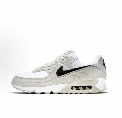 Nike Air Max 90 sneakers, angled profile in white/beige with black swoosh and air sole