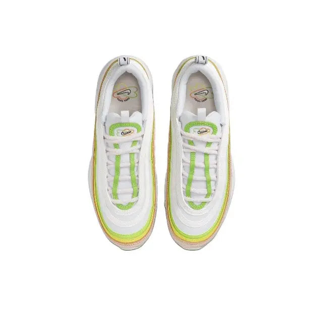 Pair of running sneakers, white uppers with green laces and yellow trim around edges