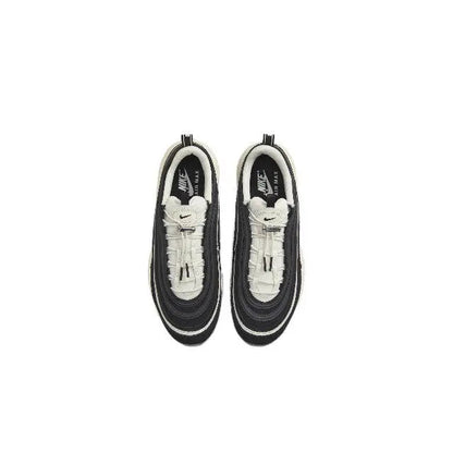 Nike sneaker pair, black and white interior with laces and Swoosh on tongue