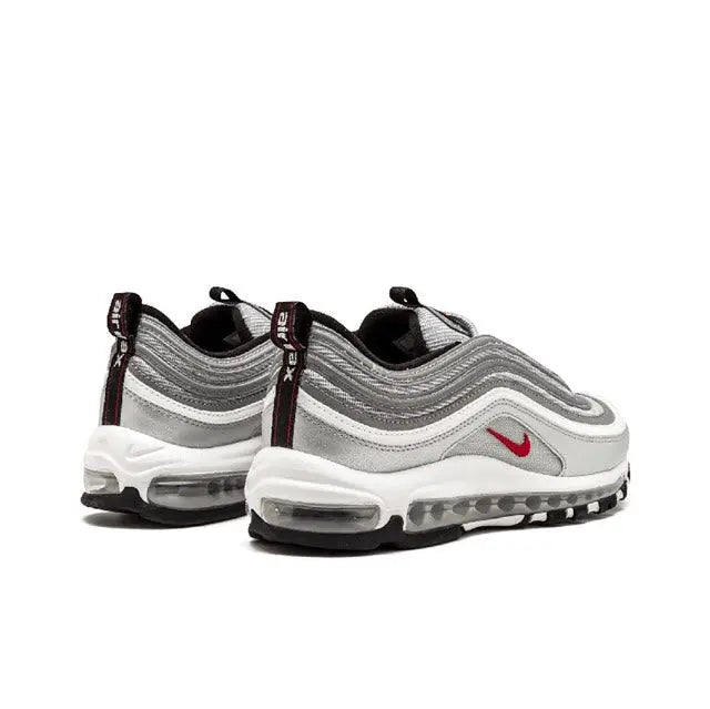 Silver lace-up running shoes with red swoosh and air-cushioned sole