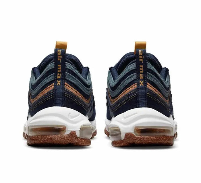 Pair of navy running shoes with white midsole, brown speckled outsole, tan lace tabs