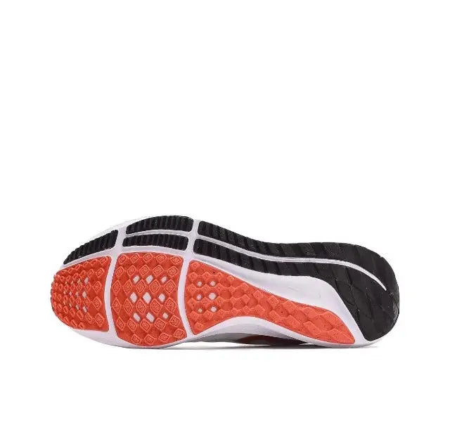 Shoe outsole with red tread, white midsole, black rubber sections for traction