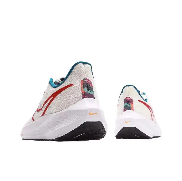 White Nike running shoe heel view with red side panel, teal collar, padded heel