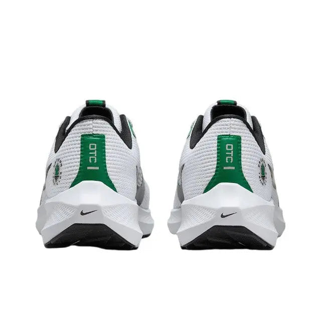 Rear view of white running shoe with green heel pull tab and black collar