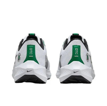 Rear view of white running shoe with green heel pull tab and black collar
