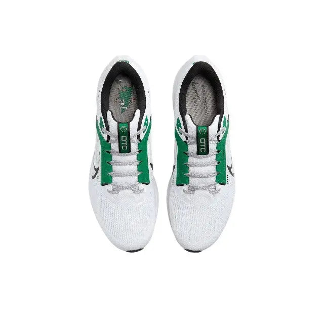 Pair of white running shoes with green lace accents and cushioned heel openings