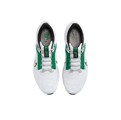 Pair of white running shoes with green lace accents and cushioned heel openings