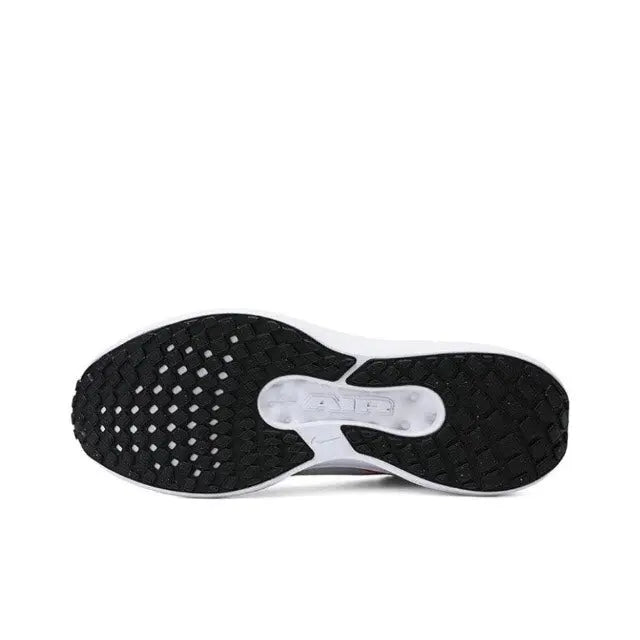 Nike running shoe outsole, dark tread with patterned grip and white midfoot panel