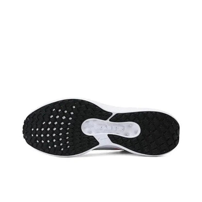 Nike running shoe outsole, dark tread with patterned grip and white midfoot panel