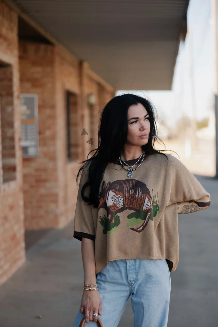 Tan graphic knit sweater with armadillo front print and short wide sleeves